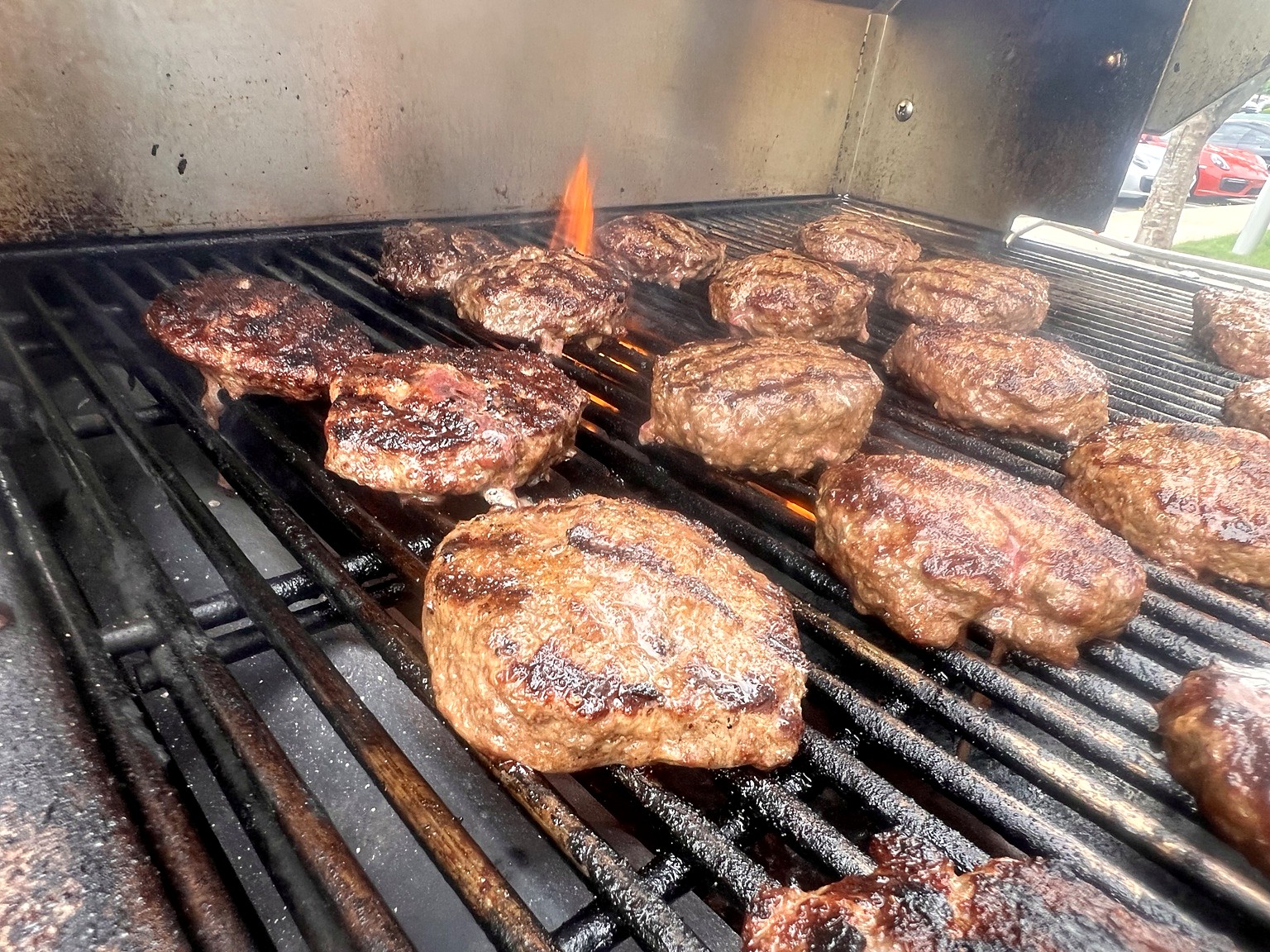 Burgers sizzling on the Coachman catering grill