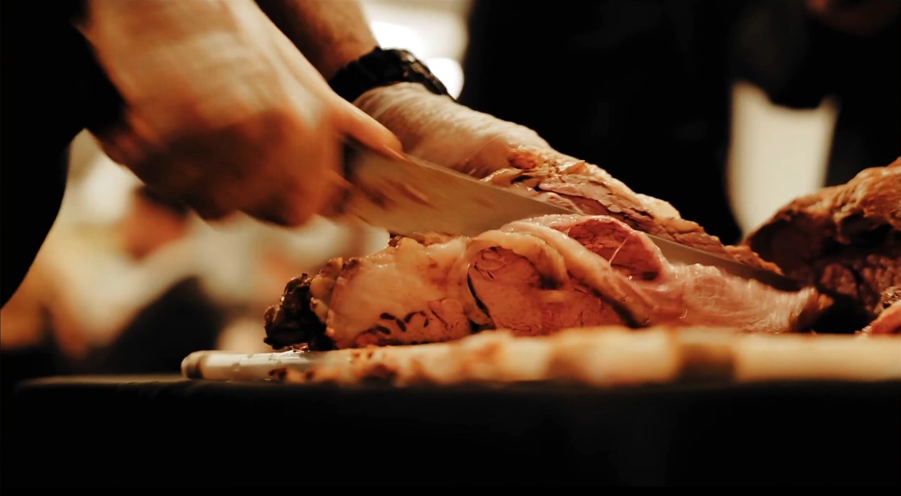 Prime rib being carved for a catered event